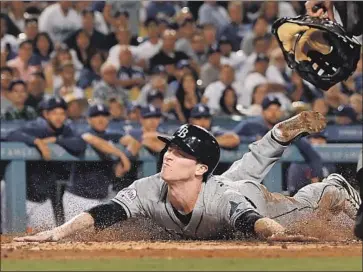  ?? Jayne Kamin-Oncea Getty Images ?? JOEY WENDLE of the Rays scores on a sacrifice fly by Willy Adames off Caleb Ferguson in the second inning at Dodger Stadium. Tampa Bay then was held scoreless by three Dodgers relievers over the next three innings.