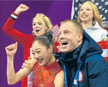  ?? Roberto Schmidt AFP/Getty Images ?? MIRAI NAGASU, front left, celebrates with coach Tom Zakrajsek after a long program in the figure skating team event in which she became the first American woman to land a triple axel jump in an Olympics.