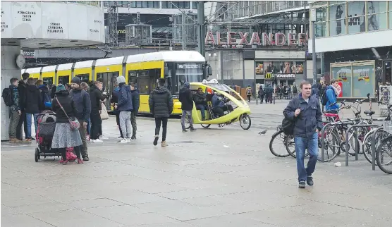  ?? RICHARD WHITE ?? Berlin’s Alexanderp­latz is a vibrant pedestrian zone, surrounded by a major subway train station and home to department stores and smaller shops.