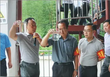  ?? PROVIDED TO CHINA DAILY ?? Meng Qiliang, vice-chairman of the Guizhou Committee of the Chinese People’s Political Consultati­ve Conference (center), and Tan Hai, mayor of Chishui, Guizhou province (right), check the water quality of the Chishui River.
