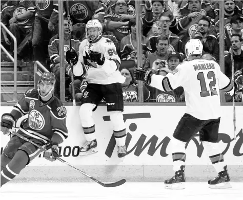  ?? JASON FRANSON/THE CANADIAN PRESS VIA AP ?? The Sharks’ Melker Karlsson (68) and Patrick Marleau (12) celebrate Karlsson’s game-winning goal in overtime.