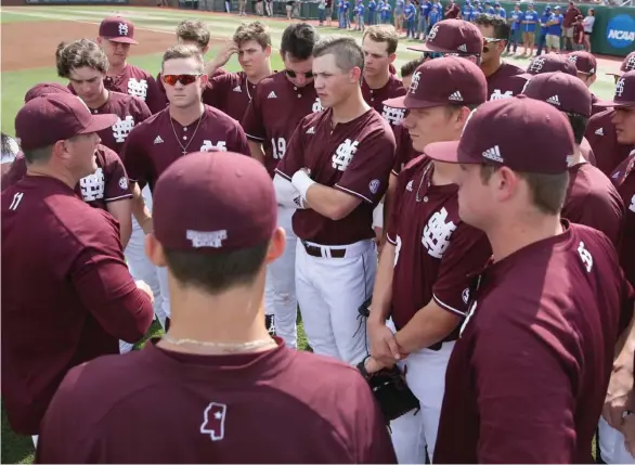  ?? (Photo by Blake Williams, MSU athletic media relations, for Starkville Daily News) ?? Mississipp­i State baseball coach Andy Cannizaro, left, visits with his team following a game during the season. The Bulldogs start Southeaste­rn Conference Tournament play today in Hoover, Ala.