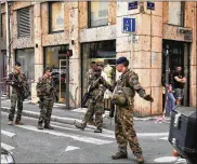  ?? SEBASTIEN EROME / AP ?? Soldiers of French anti-terrorist plan, Vigipirate Mission, secure the area near the site of a suspected bomb attack in central Lyon on Friday.