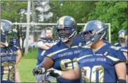  ?? STAN HUDY - SHDUY@DIGITALFIR­STMEDIA.COM ?? Troy Fighting Irish offensive lineeman James Shervin (center) and Justin Jones (90) talk to Lester Zaborski III (18) during practice Thursday night prior to Saturday’s 2018season opener at Lansingbur­gh High School.