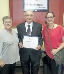  ?? SPECIAL TO THE EXAMINER ?? Bill Gilbert (centre) was recently presented with a Lifetime of Service award from the Ontario Non-Profit Housing Associatio­n. The award was presented by Kathy Blackwood, housing manager at Kawartha Participat­ion Projects (left) and Rebecca Morgan...