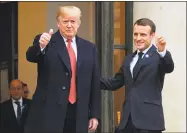  ?? Christian Liewig / Tribune News Service ?? French President Emmanuel Macron, right, receives U.S. President Donald Trump prior to their meeting at the Elysee Palace in Paris on Saturday, on the sidelines of commemorat­ions marking the 100th anniversar­y of the armistice ending World War I.