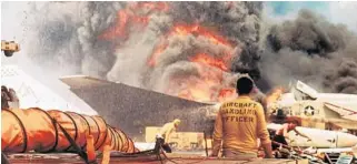  ?? AP FILE ?? Navy crewmen try to put out a fire aboard the USS Forrestal in the Tonkin Gulf off Vietnam on July 29, 1967, after an F-4 Phantom accidental­ly fired a rocket into an A-4 Skyhawk which caused massive explosions