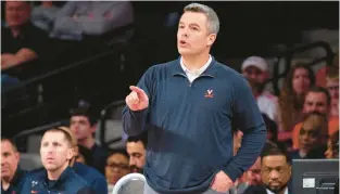  ?? HAKIM WRIGHT SR./AP ?? Virginia head coach Tony Bennett points to an official during Saturday’s game against Georgia Tech in Atlanta. Bennett tied the school record for victories.