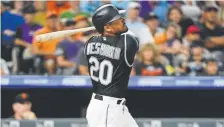  ?? Andy Cross, The Denver Post ?? Colorado’s Ian Desmond hits a double scoring Charlie Blackmon to take the lead 5-4 in the 7th inning.