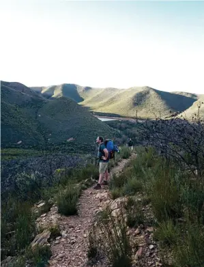  ??  ?? HILL AND VALE. The scenery and route profile on the Arangiesko­p Trail changes constantly. One moment you’re walking through open grass on level terrain, the next you’re hanging onto chains in a gorge where ferns as big as umbrellas grow.