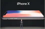  ?? JOSH EDELSON — AGENCE FRANCE-PRESSE VIA GETTY IMAGES ?? Apple CEO Tim Cook unveils the new iPhone X during a media event Tuesday at the Steve Jobs Theater on the new Apple campus in Cupertino.