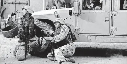  ??  ?? Eric Bourquin (Jon Beavers, left) and Ben Hayhurst (Patrick Schwarzene­gger) take cover. VAN REDIN/NATIONAL GEOGRAPHIC