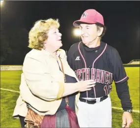  ?? Catherine Avalone / Hearst Connecticu­t Media ?? Bette DeMayo, left, congratula­tes her husband and North Haven head coach Bob DeMayo after winning the Class L state championsh­ip on June 13, 2015.