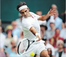  ?? CLIVE MASON GETTY IMAGES ?? Superstar Roger Federer of Switzerlan­d returns against Lukas Lacko of Slovakia during their men’s singles second-round match at the Wimbledon Lawn Tennis Championsh­ips in London on Wednesday. Federer won in straight sets, 6-4, 6-4, 6-1.