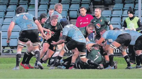  ??  ?? RGC forward Evan Yardley (green) on the attack against Neath. Pic: Alan Skeates.