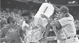  ?? YLE ROSS/USA TODAY SPORTS ?? Phillies pitcher Ranger Suarez, second from left, gets showered by second baseman Bryson Stott, right, and outfielder Brandon Marsh after pitching a shutout against the Colorado Rockies on Tuesday in Philadelph­ia.