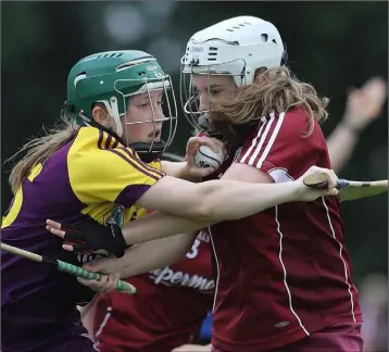  ??  ?? Wexford’s Katie Smyth is tackled by Joanne Daly of Galway.