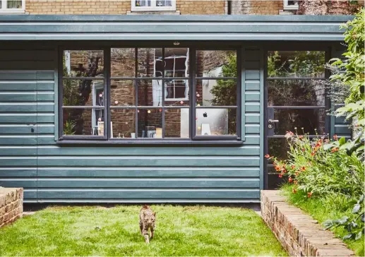  ??  ?? GARDEN OFFICE Above Francisca’s bright working space in the garden replaced a ramshackle shed Left Farrow & Ball’s energising Rectory Red was chosen for the walls while a print by Liu Haiming and an Orla Kiely fabric add interest