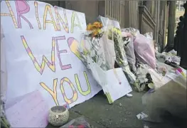  ?? Rui Vieira Associated Press ?? FLORAL TRIBUTES are left in St. Ann’s Square in Manchester, England, after 22 people were killed in a suicide bombing at an Ariana Grande concert in 2017.