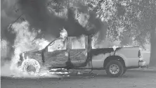  ?? THE ASSOCIATED PRESS ?? Flames consume a truck in Lower Lake, California, during the 2016 wildfires. Total area burned in U.S. has doubled in the past 30 years.