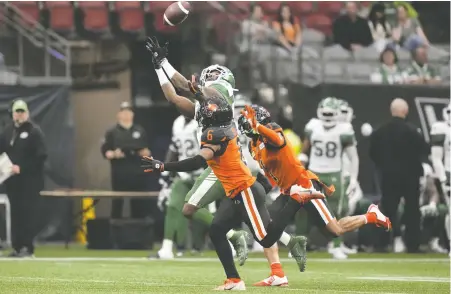  ?? DARRYL DYCK/THE CANADIAN PRESS ?? Saskatchew­an receiver D'haquille Williams reaches but fails to make the reception as Lions' defensive backs T.J. Lee and Garry Peters defend during pre-season action at B.C. Place Stadium on Friday night.