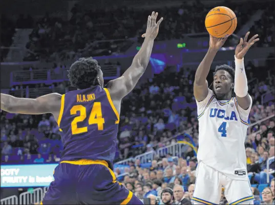  ?? Allison Dinner The Associated Press ?? UCLA guard Will Mcclendon, a Bishop Gorman High product, shoots against California forward Sam Alajiki in a Pac-12 game on Feb. 18. It would be a dream Sweet 16 matchup to see the Bruins face fellow West Regional power Gonzaga at T-mobile Arena.