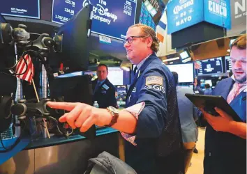  ?? AFP ?? Traders at the New York Stock Exchange. Stocks closed up nearly 200 points following news of a strong jobs report and other indicators.