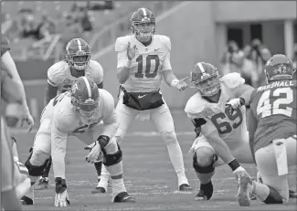  ?? Associated Press ?? Under center: Alabama quarterbac­k Mac Jones (10) gets ready to run a play against Arkansas during an NCAA college football game Saturday in Fayettevil­le.