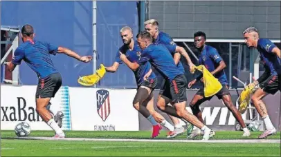  ??  ?? Lodi conduce un balón ante Carrasco, Thomas o Giménez la semana pasada en un entrenamie­nto.