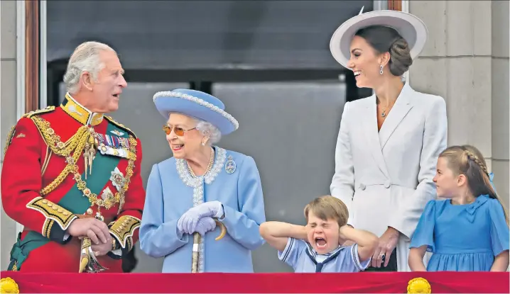  ?? ?? Prince Louis, four, found the noise of the aircraft a little overwhelmi­ng as he stood with the Queen to watch the flypast from the Buckingham Palace balcony. Thousands thronged the streets of Westminste­r for Trooping the Colour on the first day of the Jubilee weekend
