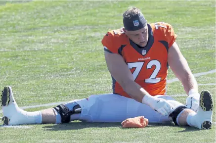  ?? David Zalubowski, The Associated Press ?? Broncos left tackle Garett Bolles stretches before taking part in drills at training camp this week.