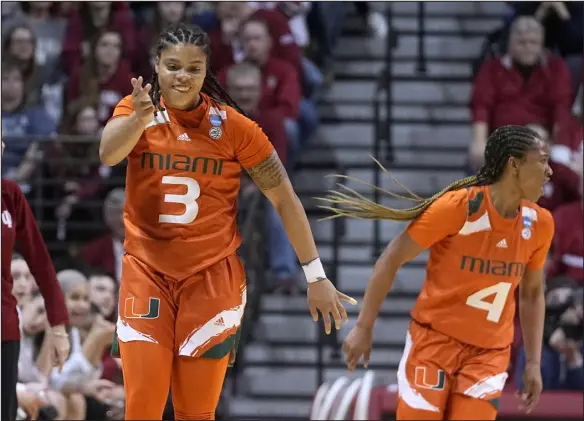  ?? DARRON CUMMINGS — THE ASSOCIATED PRESS ?? Miami’s Destiny Harden (3) celebrates along with teammate Jasmyne Roberts (4) during the first half of a second-round NCAA Tournament game against Indiana Monday in Bloomingto­n, Ind.