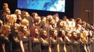 ?? REBECCA BLANCHARD — DIGITAL FIRST MEDIA ?? Choirs from both schools combine and hold hands to perform “We Shall Overcome.”