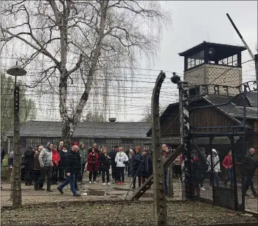  ?? JULIETTE MAYNIAL/AFP VIA GETTY IMAGES ?? Philippe Maynial, nephew of doctor Madeleine Pauliac, and relatives of the 11 nurses, who belonged to the French Red Cross Blue Squadron, visit the former German Nazi death camp Auschwitz-Birkenau, in Oswiecim, Poland, on April 13, 2019. Dr. Pauliac establishe­d the French hospital in Warsaw in March 1945, joined by nurses of the French Red Cross Blue Squadron. The makeshift dispensary welcomed hundreds of French soldiers from the German Nazi camps 74 years ago.