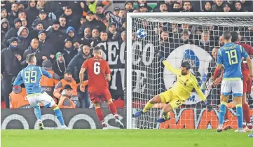  ??  ?? Liverpool’s Brazilian goalkeeper Alisson Becker (second right) saves a shot from Napoli’s Polish striker Arkadiusz Milik (left) during the UEFA Champions League group C football match between Liverpool and Napoli at Anfield stadium in Liverpool. — AFP photo