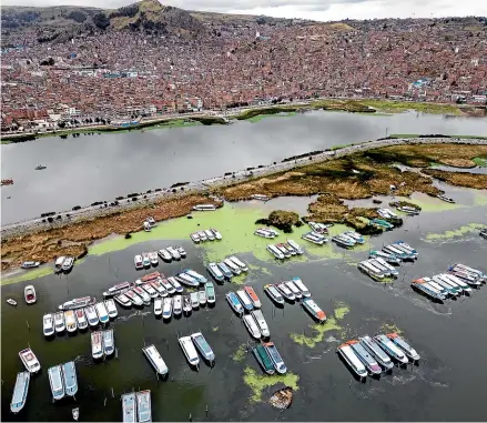  ?? AP ?? Boats stand idle on the shore of Lake Titicaca due to the political unrest in Peru.