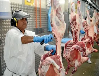  ?? PHOTO: CAMERON BURNELL/FAIRFAX NZ ?? A worker processes lamb for export to Iran at the Taylor Preston plant in Wellington.