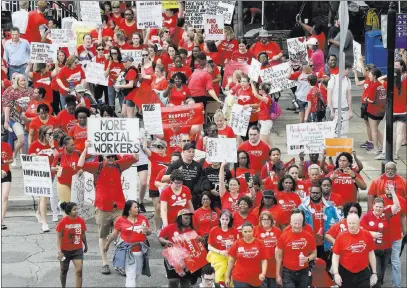  ?? Gerry Broome ?? The Associated Press Participan­ts make their way toward the Legislativ­e Building during a teacher’s rally Wednesday at the General Assembly in Raleigh, N.C. Thousands of teachers rallied in the state capital seeking a political showdown over wages and...