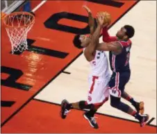  ?? FRANK GUNN — THE CANADIAN PRESS VIA AP ?? Toronto’s Kyle Lowry (7) stops Washington’s John Wall during the second half of Game 1 in Toronto, Saturday. (2)