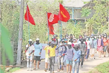  ?? — AFP photo ?? This handout photo shows protesters holding flags as they march in a demonstrat­ion against the military coup in Launglone township in Myanmar’s Dawei district.