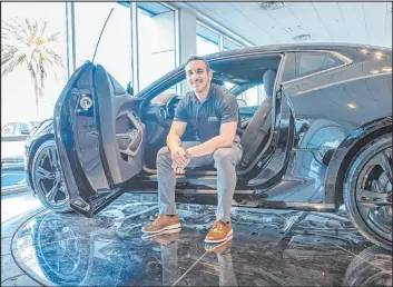  ?? Team Automotive Group ?? Matthew Bomareto, general manager of Team Chevrolet, is ready to greet official grand opening customers alongside a new 2022 Camaro.