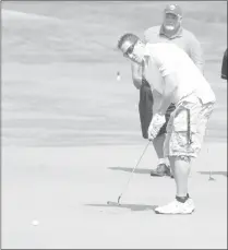  ?? Herald photo by Dale Woodard ?? Scott Grieco sends a putt toward the pin as Daryn Wenaas keeps an eye on the shot at the Hurricanes Golf Classic at the Paradise Canyon Golf Resort Monday afternoon.