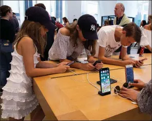  ?? AP/MARK LENNIHAN ?? Customers fill an Apple store in New York in early August. U.S. consumer spending showed strong growth in June and July, the government said Thursday.