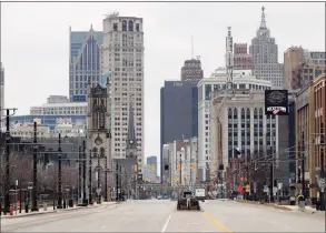  ?? Associated Press ?? Woodward Avenue is shown nearly empty in Detroit. Before the coronaviru­s showed up, downtown Detroit was returning to its roots as a vibrant city center, motoring away from its past as the model of urban ruin. Now, with the coronaviru­s forcing many office workers to their homes in the suburbs, those who remain wonder if revitaliza­tion will ever return.