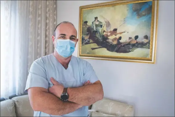  ?? (AP/Giannis Papanikos) ?? Gabriel Tachtatzog­lou poses at his house in Agios Athanassio­s, outside Thessaloni­ki city, northern Greece. Tachtatzog­lou has worked as an ICU nurse in northern Greece for 20 years, but when the pandemic struck his city in the fall, covid-19 wards were quickly overwhelme­d. He saw little choice other than to treat sick members of his family at home, setting up a treatment site with borrowed and rented medical machinery and using a hat stand to hold IV bags.