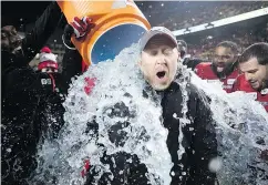  ?? — THE CANADIAN PRESS ?? Stampeders head coach Dave Dickenson gets a water bucket dumped on him after his team defeated the Redblacks in the Grey Cup Sunday.