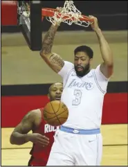  ?? Associated Press ?? DUNKER — Los Angeles Lakers forward Anthony Davis (3) dunks over Houston Rockets forward P.J. Tucker (17) during the first quarter on Sunday at Toyota Center in Houston. The Lakers won 120-102.