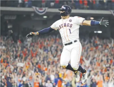  ??  ?? Astros shortstop Carlos Correa celebrates Sunday night after hitting a two-run homer against the Los Angeles Dodgers during the seventh inning of Game 5 of the World Series at Minute Maid Park in Houston. David J. Phillip, The Associated Press World...