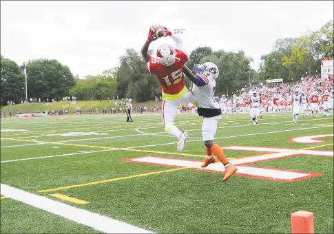  ?? Matthew Brown / Hearst Connecticu­t Media ?? Greenwich’s AJ Barber catches a pass for a touchdown against Danbury’s Xavier Ross in the season opener for both teams in this FCIAC contest at Cardinal Stadium in Greenwich on Saturday.