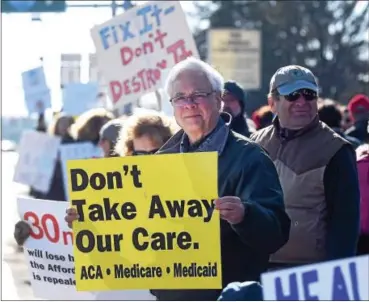  ?? PETE BANNAN – DIGITAL FIRST MEDIA ?? Ron Ploeg of Rose Valley protests outside U.S. Rep. Pat Meehan’s Springfiel­d office Sunday, following U.S. Sen. Bernie Sanders’ call for nationwide rallies to protest GOP plans to dismantle Obamacare and revamp Medicaid. “I’m open to listening to a...